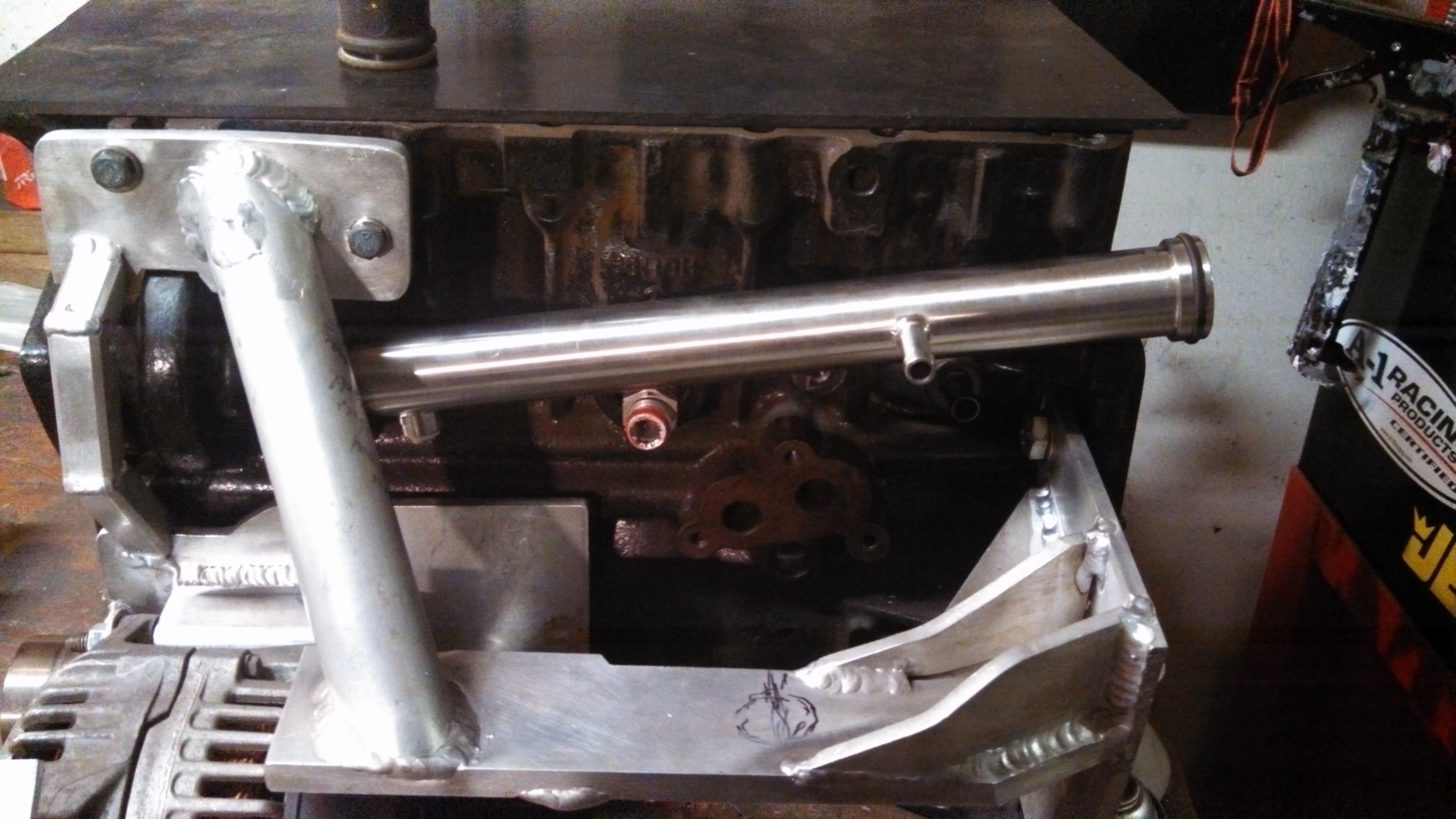 coolant pipe and drv side eng mount arm.jpg